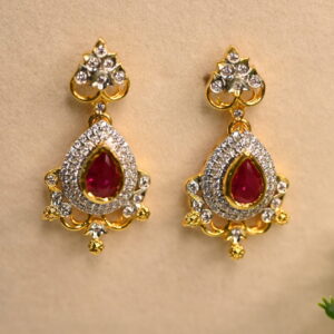 "A pair of CZ drop earrings with a ruby-colored stone." "Gold-tone CZ earrings with a teardrop design." CZ