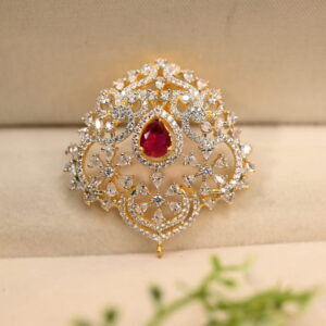 The image shows a close-up of a jewelry pendant. The pendant appears to be made of gold or a gold-toned metal.