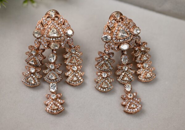 The image shows a pair of stunning rose gold chandelier earrings. The earrings feature multiple strands of sparkling moissanites, creating a cascading effect. The intricate design and the brilliance of the moissanites make these earrings a true showstopper. The rose gold setting adds a touch of warmth and elegance to the overall look.