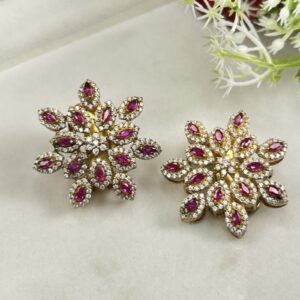 The image showcases a pair of elegant earrings featuring a radiant floral design. The earrings appear to be made with high-quality moissanite stones, set in a lustrous metal, likely gold or silver.
