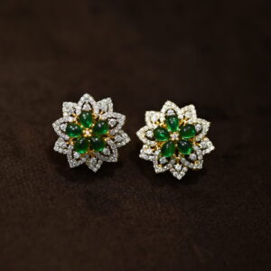 This image showcases a pair of elegant stud earrings featuring a floral design. The earrings are crafted with a combination of sparkling cubic zirconia (CZ) stones and vibrant green gemstones, creating a beautiful contrast. Floral