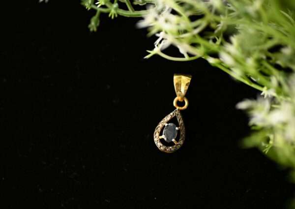 The image showcases a delicate and elegant pendant crafted from 925 sterling silver. The pendant features a central diamond, possibly a single stone or a cluster, set within a graceful design. The 925 hallmark, indicating sterling silver purity, is likely visible somewhere on the pendant or its accompanying chain.
