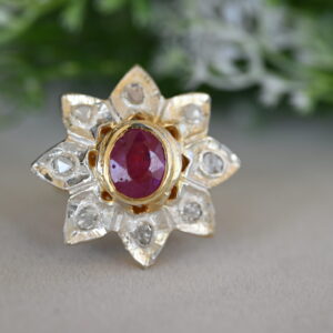 The image showcases a unique and captivating ring, likely a cocktail ring, crafted with exquisite artistry.