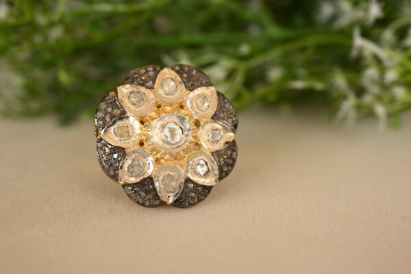 The image you sent shows a ring with a unique, floral design. The image doesn't provide a clear view of the metal used for the ring. It could be gold, silver, or another precious metal. The size and exact number of diamonds are difficult to determine from the image. "Classic Diamond Cluster Ring"