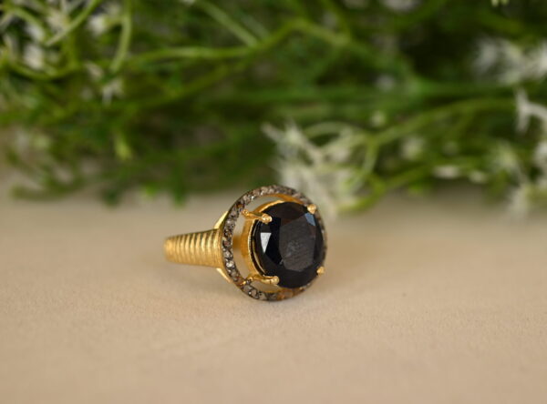 This stunning ring features a captivating black onyx gemstone encircled by a halo of sparkling diamonds. Sterling Silver Diamond Ring