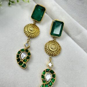 The image shows a pair of elegant earrings. Shape: The main part of the earring seems to be a rectangular or square shape, possibly made of metal. Material: The earrings are likely made of metal, possibly gold-plated or silver. Color: The earrings appear to have a warm, golden color, which would complement a variety of skin tones.