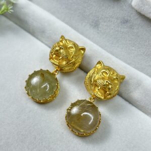 The image shows a pair of gold-toned earrings with a tiger head design.