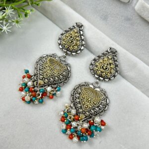 These are ornate, traditional-style earrings made of oxidized silver with gold detailing. They feature teardrop shapes and colorful dangling beads in turquoise, red, and white. Perfect for ethnic or festive wear.