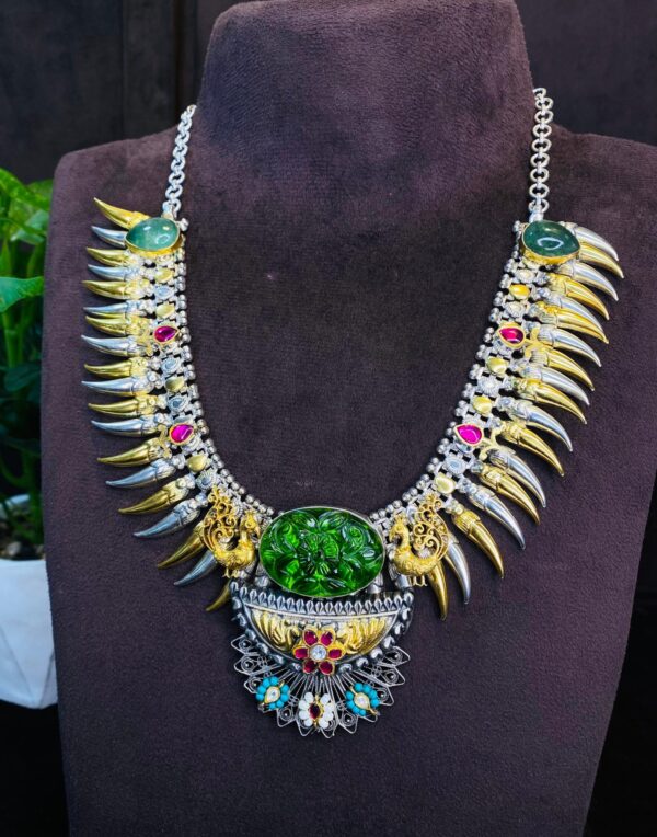 The image quality is good, allowing for a clear view of the necklace's details. The background appears to be dark, which helps to highlight the necklace's colors and textures.