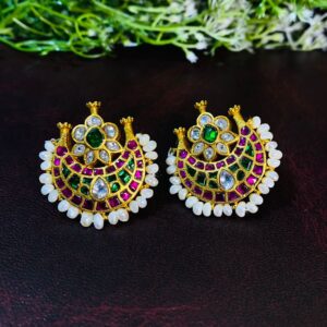The image shows a pair of exquisite Kundan earrings, meticulously crafted with a blend of traditional artistry and modern design.