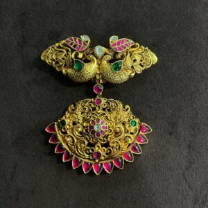 "A close-up of a gold Kundan pendant with pink and green gemstones." "Two gold motifs with Kundan stones and colorful gemstones." Pink & Green