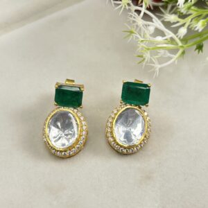 The image shows a pair of elegant earrings featuring a combination of moissanite and emerald gemstones.