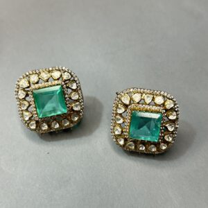 The image shows a pair of stunning moissanite earrings. The square shape of the central moissanite stones gives them a modern and sophisticated look.