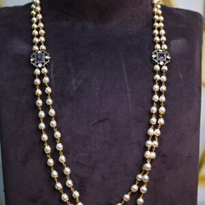 The image shows a necklace with a double strand of pearls and two prominent embellishments. The pearls are white and appear to be evenly sized and spaced along the strands. 925 Silver Jewellery