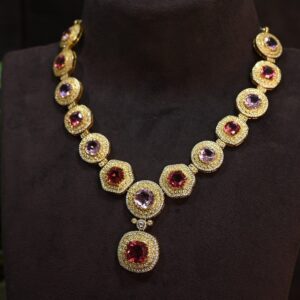 The image showcases a stunning necklace adorned with multiple moissanite gemstones. The necklace appears to be designed for formal wear, given its elaborate design and use of precious metals.