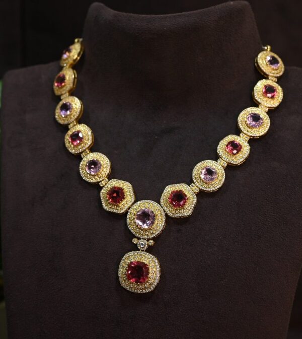 The image showcases a stunning necklace adorned with multiple moissanite gemstones. The necklace appears to be designed for formal wear, given its elaborate design and use of precious metals.