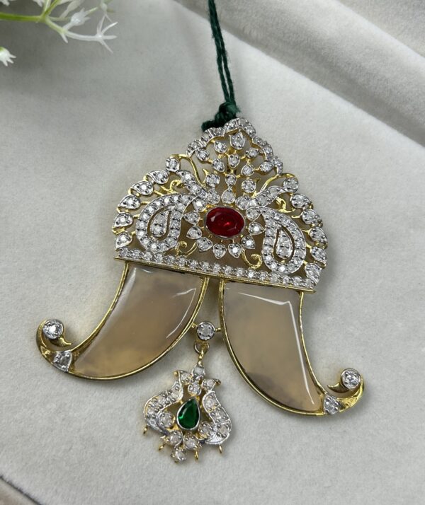 The image shows a close-up of a pendant necklace.