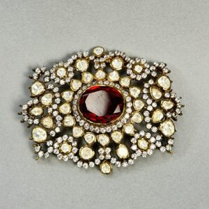 "A rectangular moissanite pendant with a large ruby in the center and surrounded by smaller diamonds." "A close-up of a vintage-style pendant with a ruby and diamond embellishments."