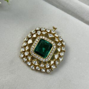 The image shows a beautiful piece of jewelry that appears to be a pendant or brooch. Here's a description based on what's visible: