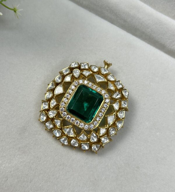 The image shows a beautiful piece of jewelry that appears to be a pendant or brooch. Here's a description based on what's visible: