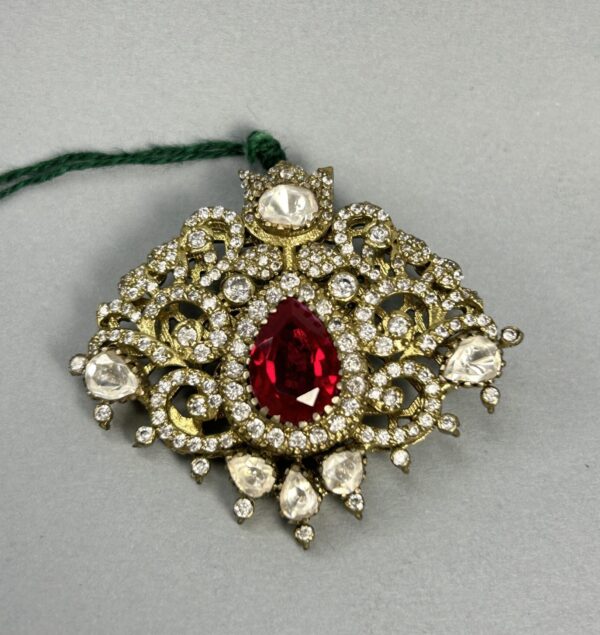"A rectangular moissanite pendant with a large ruby in the center and surrounded by smaller diamonds." "A close-up of a vintage-style pendant with a ruby and diamond embellishments." Unique Pendant