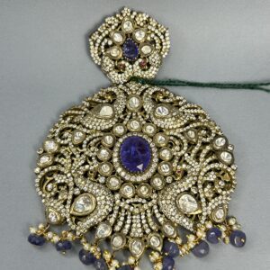 This exquisite pendant features a stunning display of moissanite stones set in a intricate floral design. The centerpiece is a large, oval-shaped blue moissanite, surrounded by a halo of smaller, sparkling moissanite stones. The pendant's frame is adorned with delicate floral motifs and intricate filigree work, creating a luxurious and elegant look.
