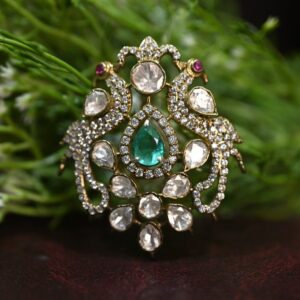 The image showcases a breathtaking moissanite pendant, a true testament to exquisite craftsmanship and design. The pendant features a mesmerizing pear-shaped emerald as its centerpiece, radiating a deep, vibrant green hue. Surrounding the emerald is a dazzling halo of sparkling moissanites, creating a brilliant and ethereal aura.