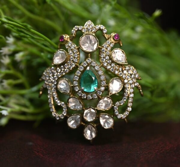The image showcases a breathtaking moissanite pendant, a true testament to exquisite craftsmanship and design. The pendant features a mesmerizing pear-shaped emerald as its centerpiece, radiating a deep, vibrant green hue. Surrounding the emerald is a dazzling halo of sparkling moissanites, creating a brilliant and ethereal aura.