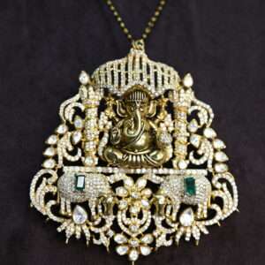 The image shows a close-up of a beautiful necklace with a large pendant. The pendant is intricately designed and features a prominent image of Lord Ganesha, the Hindu god of wisdom and prosperity.