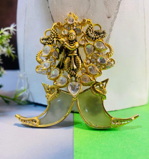The image showcases a necklace with a captivating pendant. The necklace appears to be crafted from gold or a gold-toned metal, adding to its luxurious feel. The pendant is the centerpiece, drawing the eye with its intricate design and sparkling embellishments.