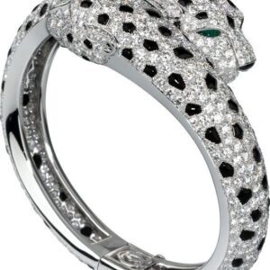 The image showcases a luxurious, intricately designed bracelet with two panther heads facing each other at the ends. The panther heads are encrusted with dazzling white stones, giving them a sparkling appearance, and each has a striking blue gemstone for an eye. The bracelet's band features a detailed pattern, with a mix of smooth and textured elements that add depth and elegance. The entire piece is silver-toned, likely made of white gold or platinum. The background includes green foliage and delicate white flowers, adding a natural, contrasting backdrop that enhances the brilliance and opulence of the jewelry. Pave Diamond Gemstone Bangle