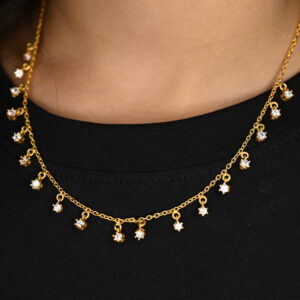 This image shows a close-up of a delicate, gold-plated choker necklace featuring a fine chain adorned with small, sparkling white diamonds set in bezels. The necklace rests on a person's neck, contrasting against a plain black top. The overall style is minimalist and elegant. 925 Silver Minimal Necklace