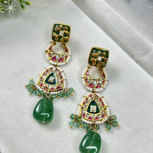 The earrings are displayed on a jewelry stand, which helps to showcase their design and size. The image is well-lit, allowing for a clear view of the details. Unique Fusion Earrings