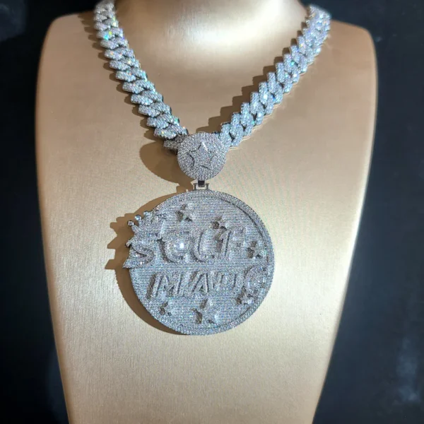This image shows a 925 silver Cuban link chain with an iced-out round pendant that reads "SELF MADE," fully covered in sparkling stones, displayed on a jewelry bust.