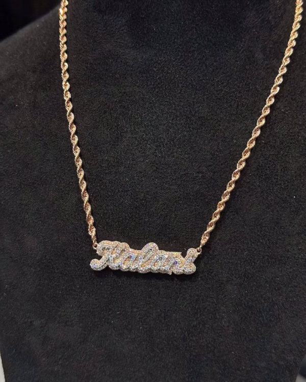 The image shows a stylish 925 sterling silver hip-hop pendant. The pendant features a bold, intricate design with sparkling stones set across its surface, giving it a brilliant, high-shine finish. Its detailed craftsmanship and iced-out look reflect a luxurious, street-inspired aesthetic, perfect for standout urban fashion.